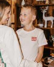 Child natural tee with 'making spirits bright' graphic, shown on model – Little Mama Shirt Shop