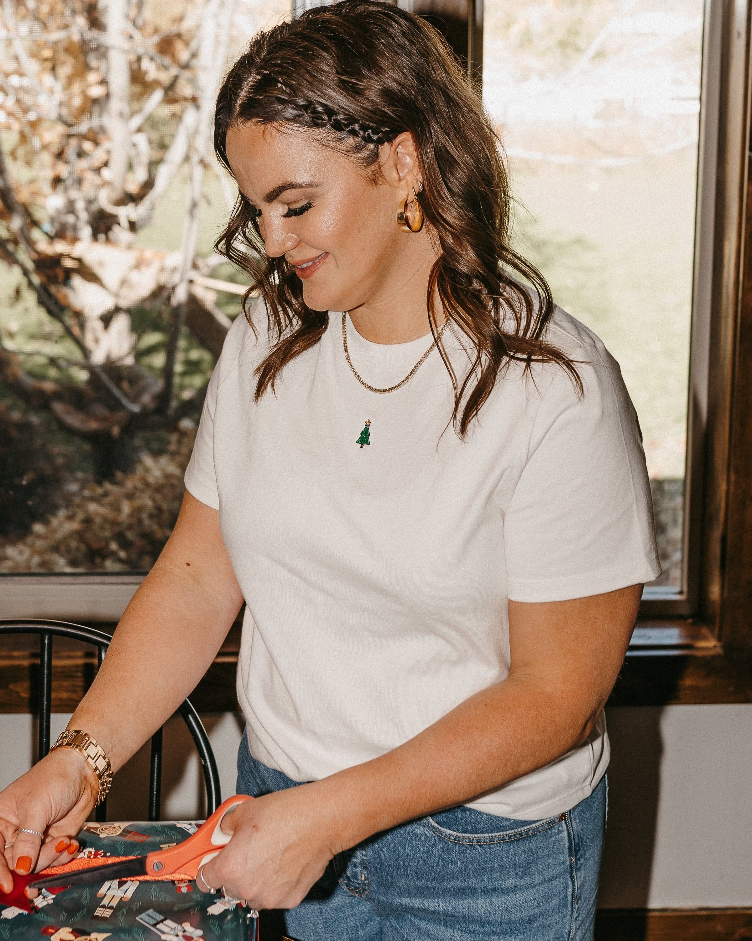 Adult tee in vintage white with Christmas mini symbol Christmas tree on front, shown on model – Little Mama Shirt Shop