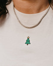 Adult tee in vintage white with Christmas mini symbol Christmas tree on front, shown on model – Little Mama Shirt Shop