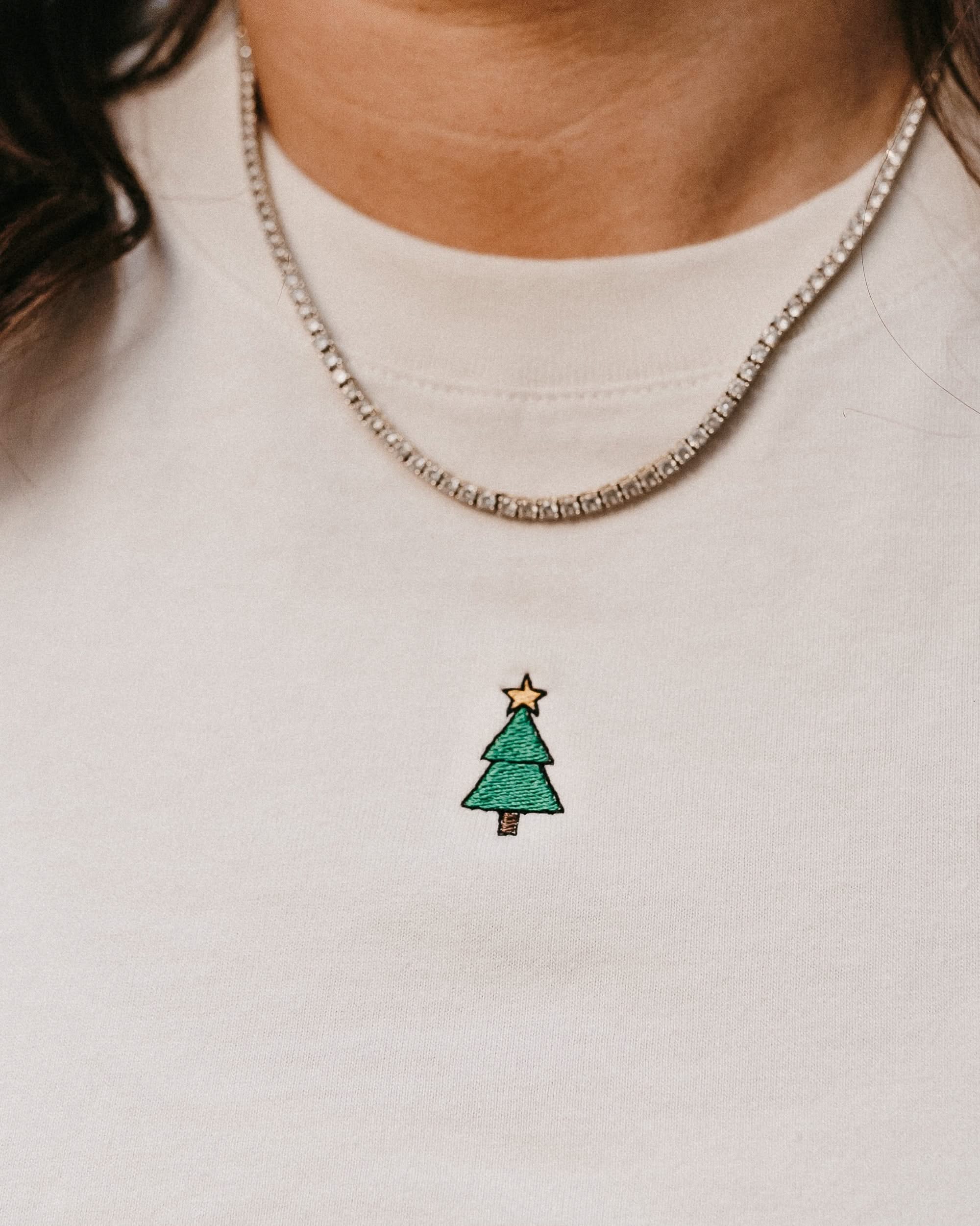 Adult tee in vintage white with Christmas mini symbol Christmas tree on front, shown on model – Little Mama Shirt Shop