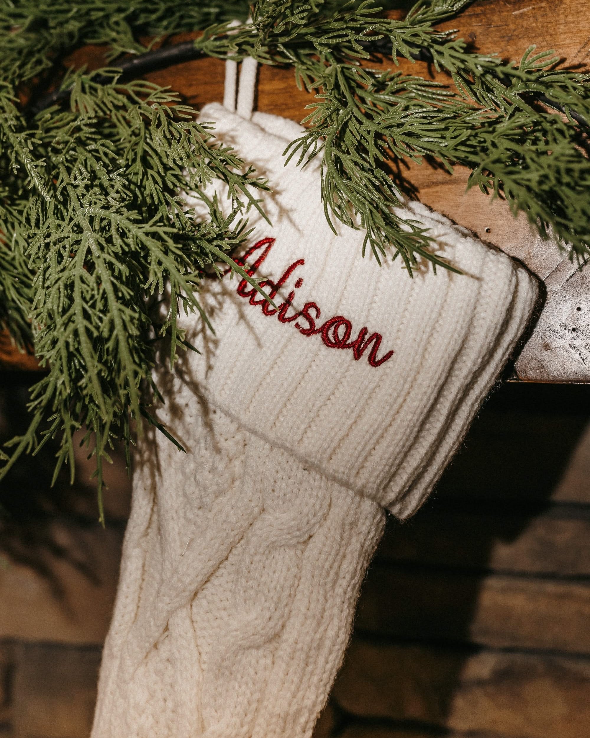 Christmas stocking in cream with personalized name printed on cuff, shown on flat lay – Little Mama Shirt Shop