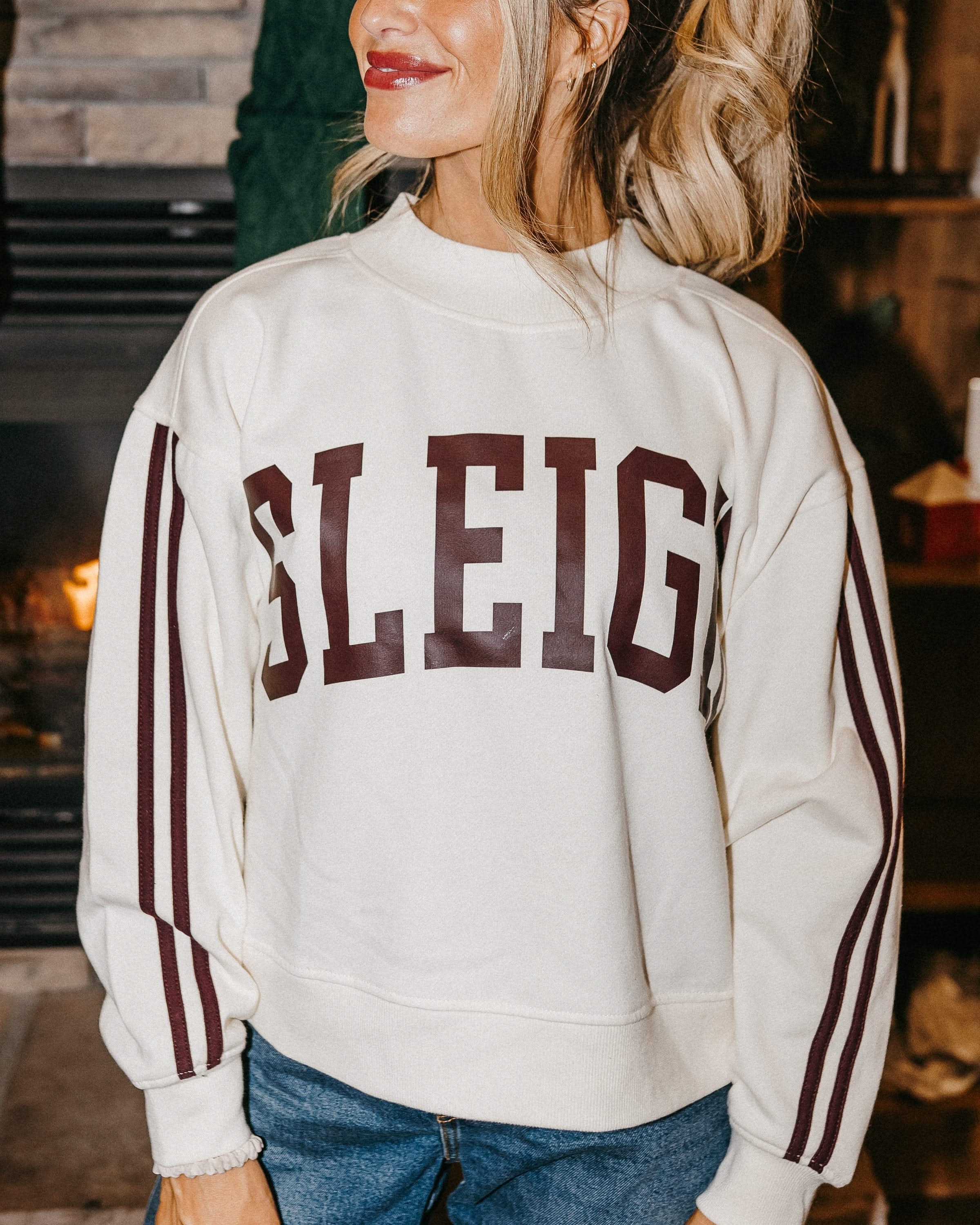 Adult mock neck sweater with varsity stripes down the arms  in white with 'sleigh' graphic on front, shown on model – Little Mama Shirt Shop