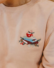 crewneck in dusty pink with embroidered stack of books on front, shown on model – Little Mama Shirt Shop