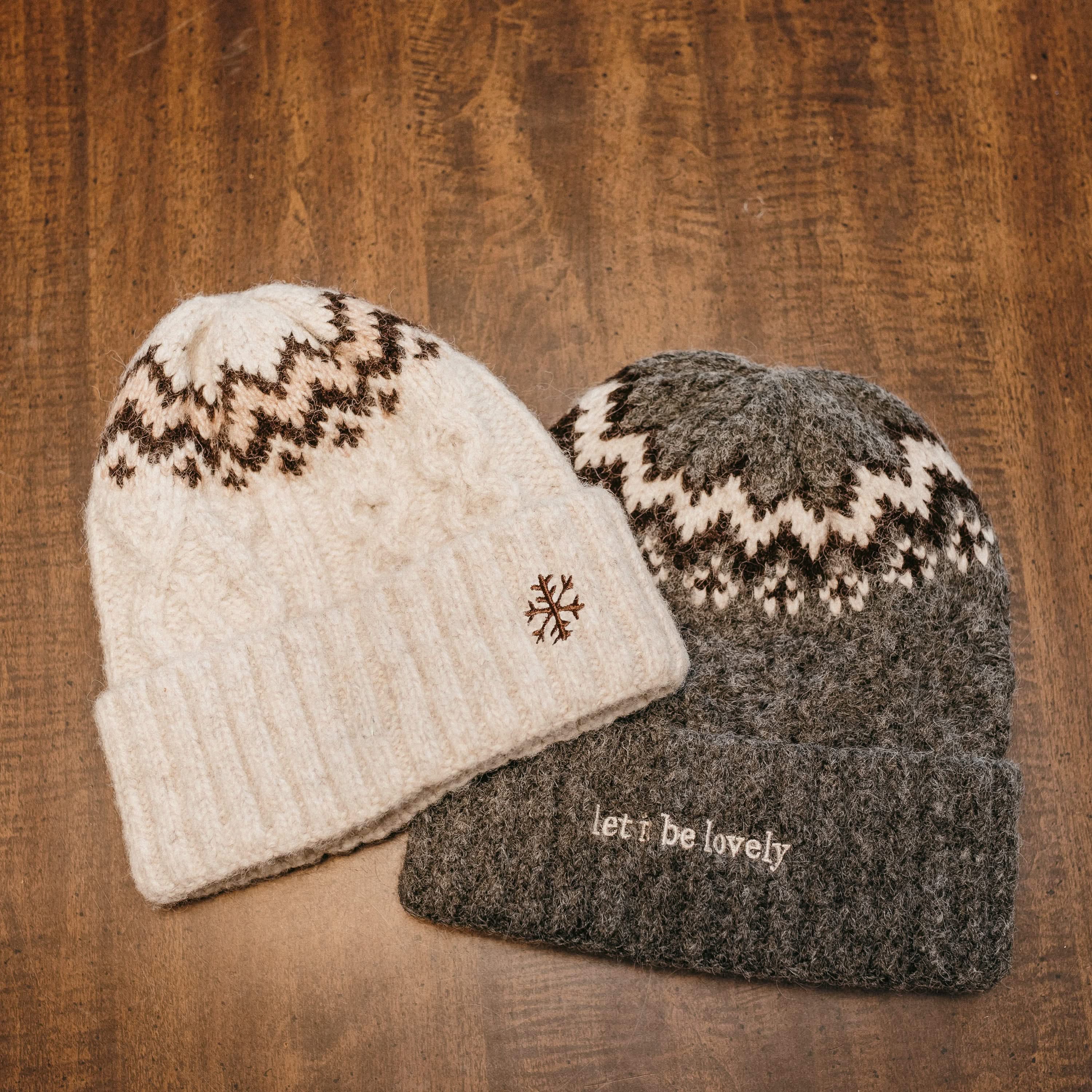 Adult beanies in cream and gray with snowflake and 'let it be lovely' designs on brim, shown on flat lay – Little Mama Shirt Shop