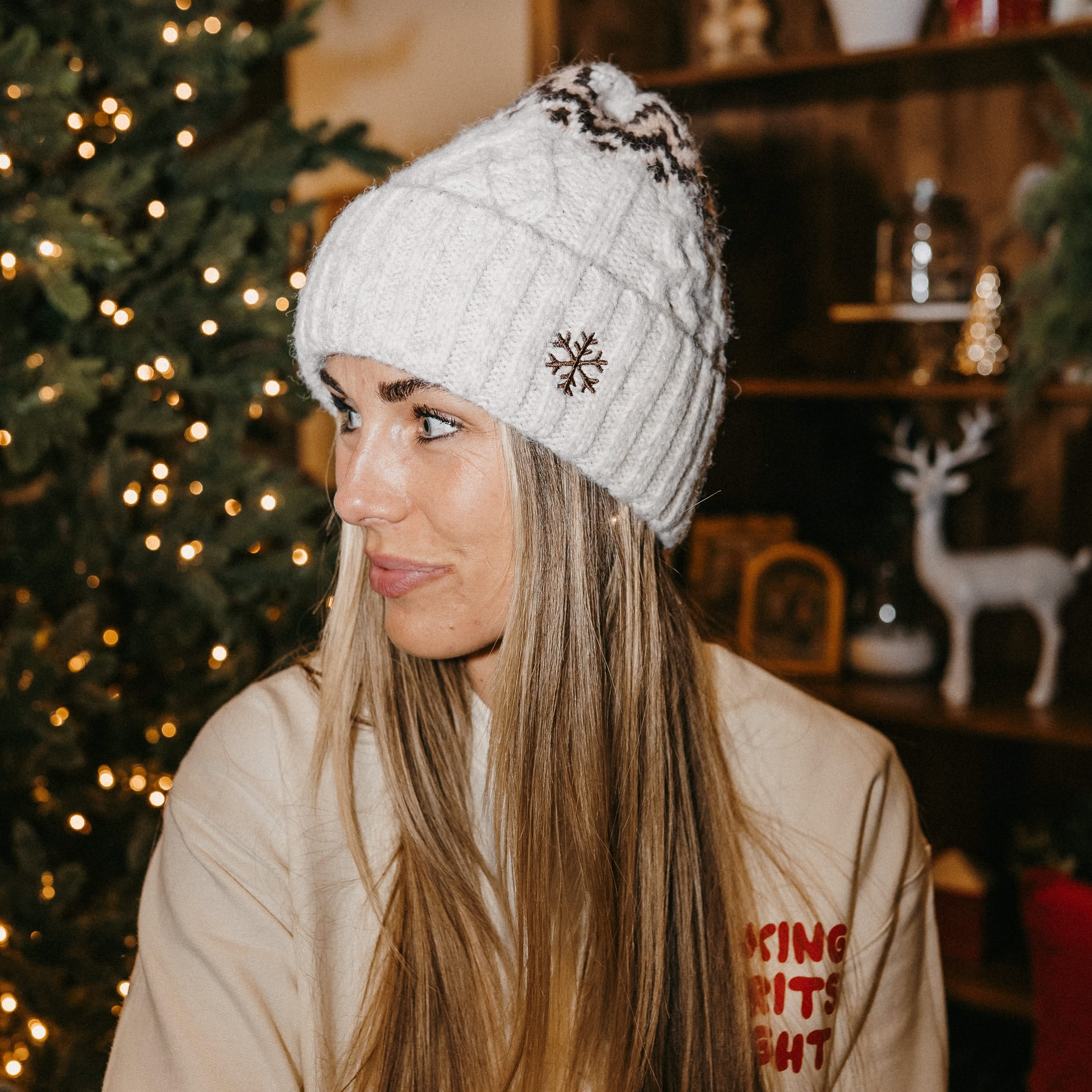 Adult beanie in cream with snowflake design on brim, shown on model– Little Mama Shirt Shop
