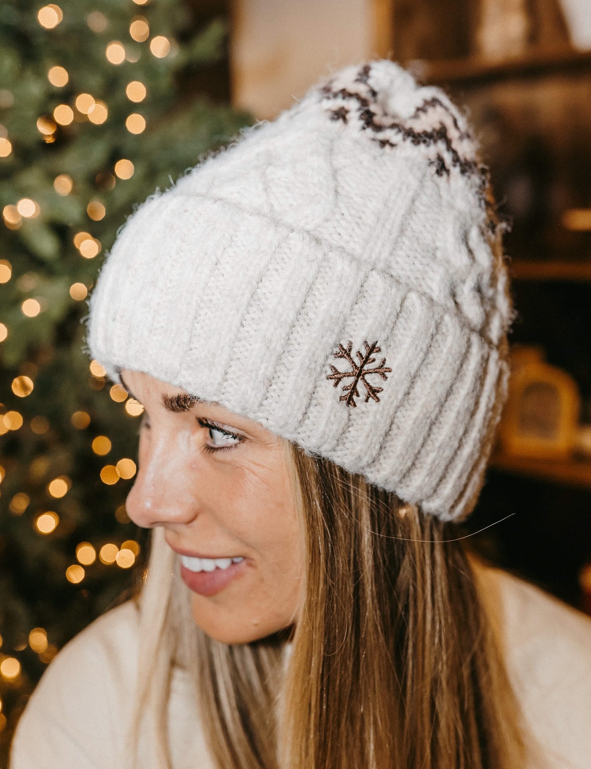 Adult beanie in cream with snowflake design on brim, shown on model– Little Mama Shirt Shop