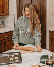 Adult mock neck sweater in green with 'Merry' graphic, shown on model – Little Mama Shirt Shop