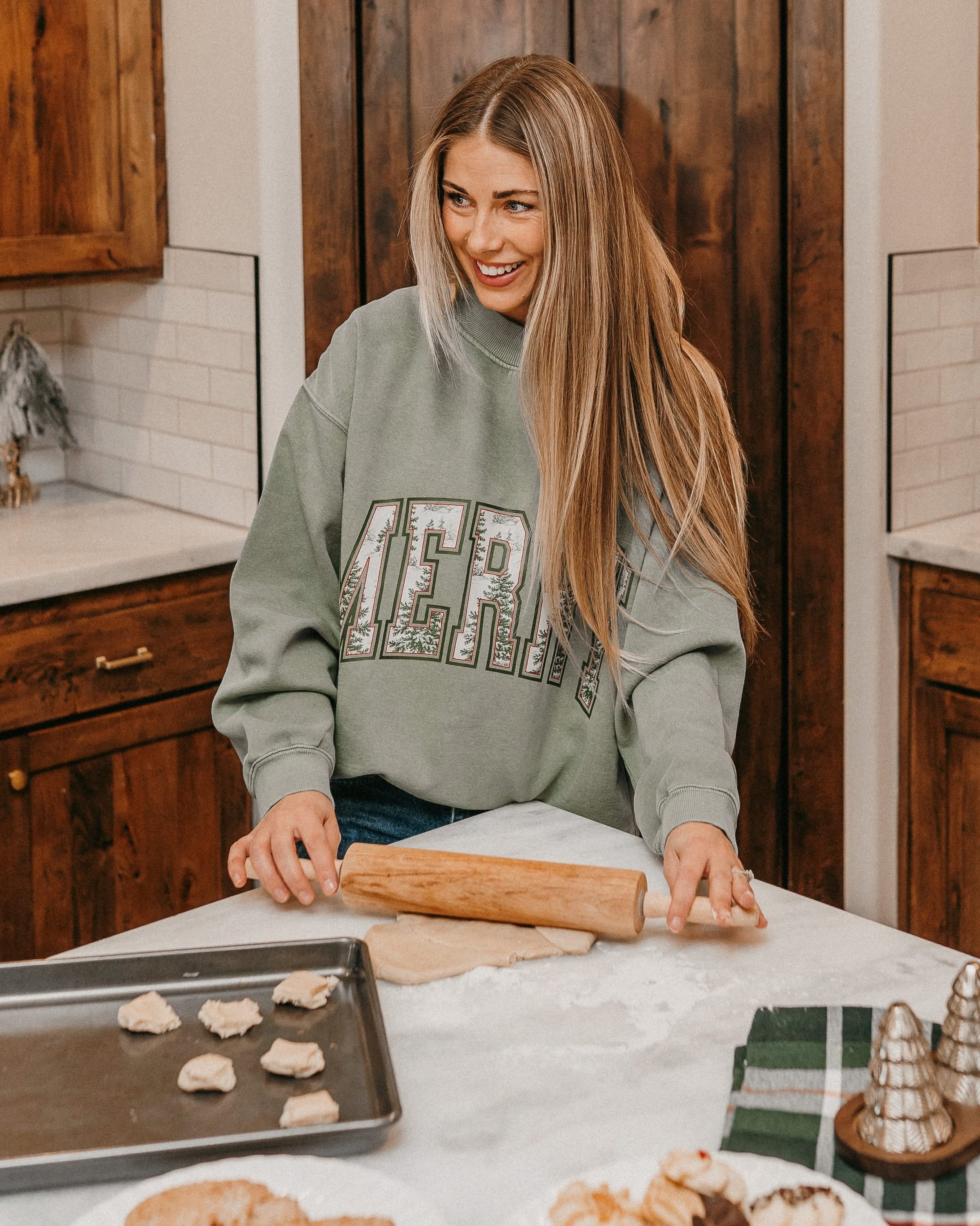 Adult mock neck sweater in green with 'Merry' graphic, shown on model – Little Mama Shirt Shop