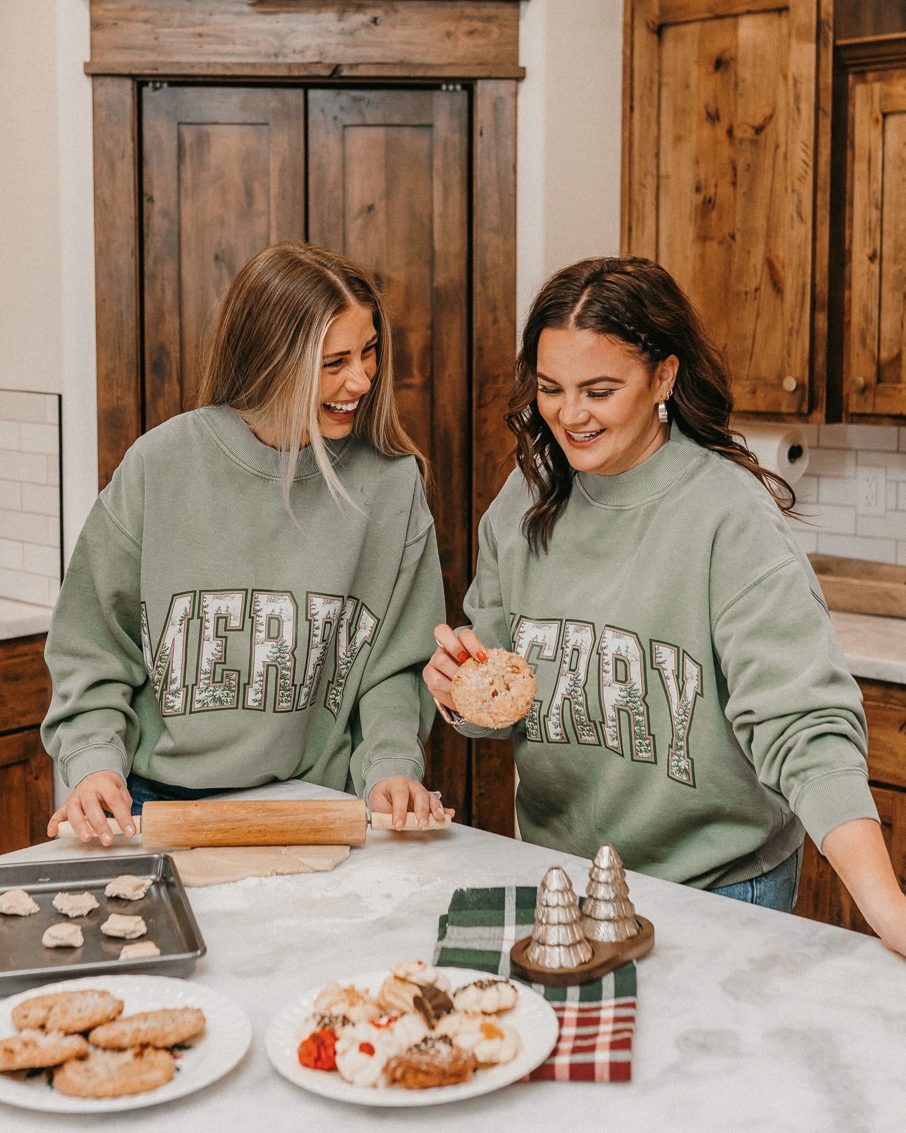 Adult mock neck sweater in green with 'Merry' graphic, shown on models – Little Mama Shirt Shop