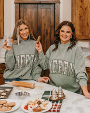 Adult mock neck sweater in green with 'Merry' graphic, shown on models – Little Mama Shirt Shop