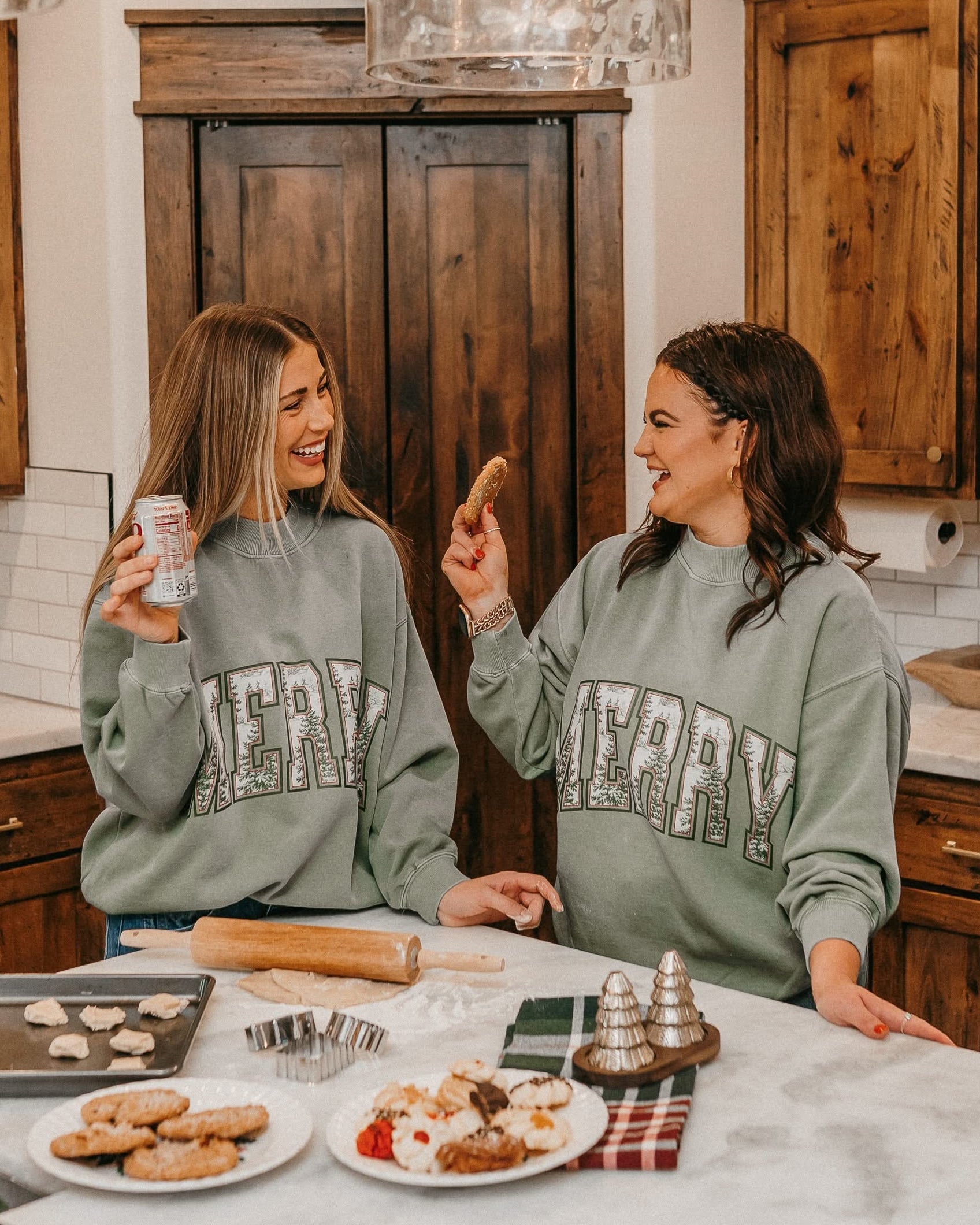 Adult mock neck sweater in green with &#39;Merry&#39; graphic, shown on models – Little Mama Shirt Shop