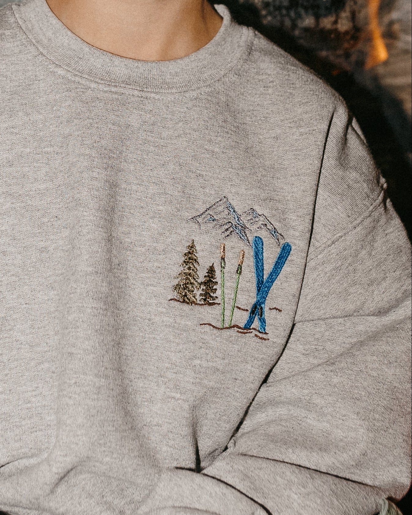 Child sweater in gray with embroidered ski pattern, shown on model – Little Mama Shirt Shop