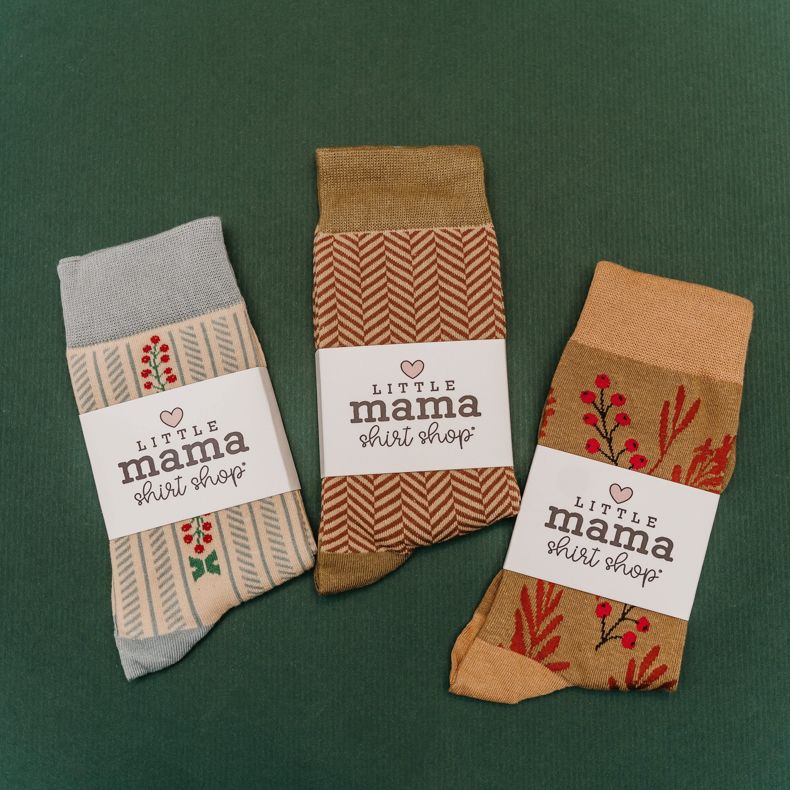 green with chevron and holly patterns, shown on flat lay – Little Mama Shirt Shop