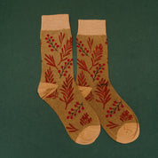Adult socks in brown/green with holly pattern, shown on flat lay – Little Mama Shirt Shop