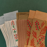 Adult socks in brown/green, cream/blue, and brown/green with chevron and holly patterns, shown on flat lay – Little Mama Shirt Shop