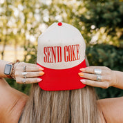 Red and cream trucker hat with bold red 'SEND COKE' text, seen on model - Little Mama Shirt Shop
