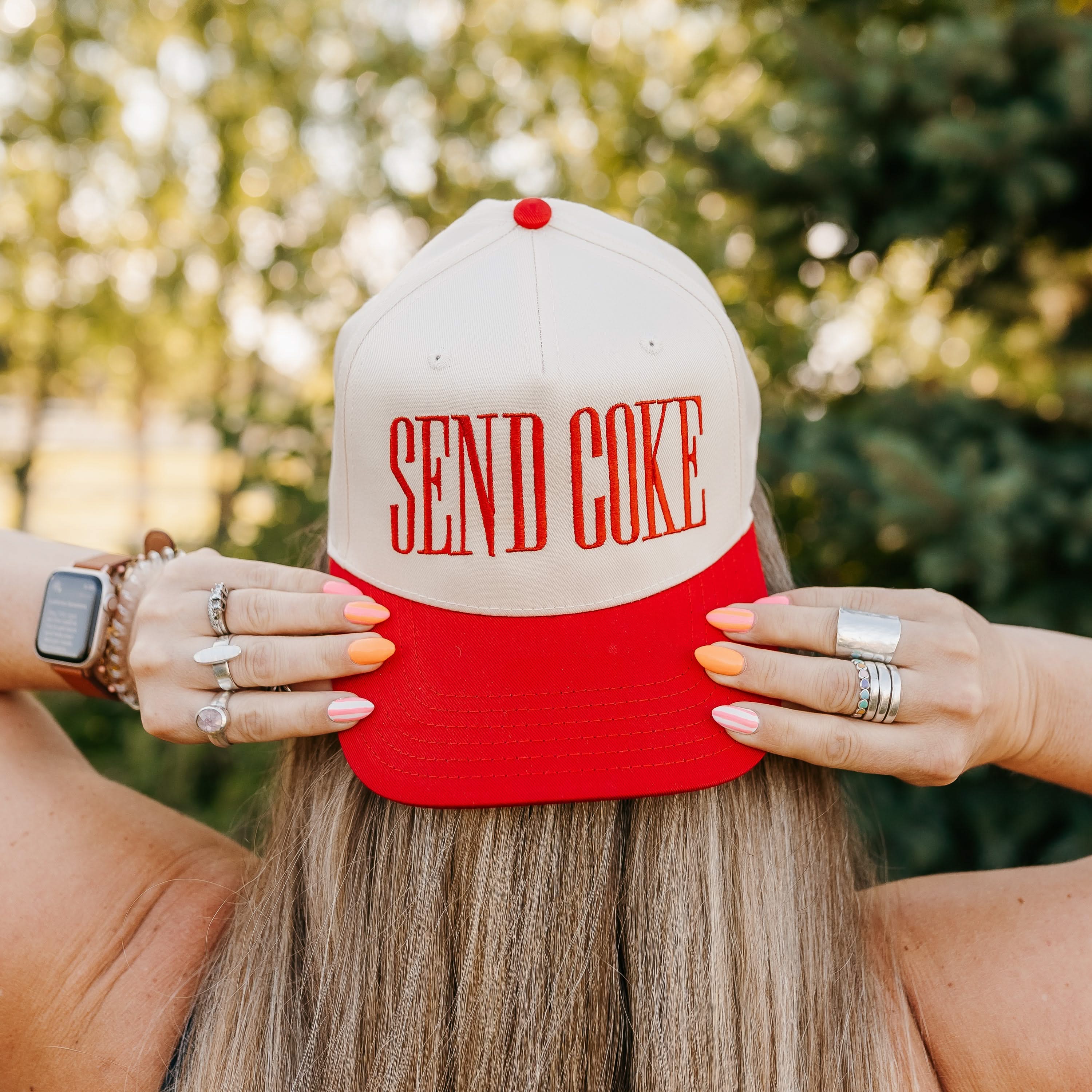 Red and cream trucker hat with bold red 'SEND COKE' text, seen on model - Little Mama Shirt Shop