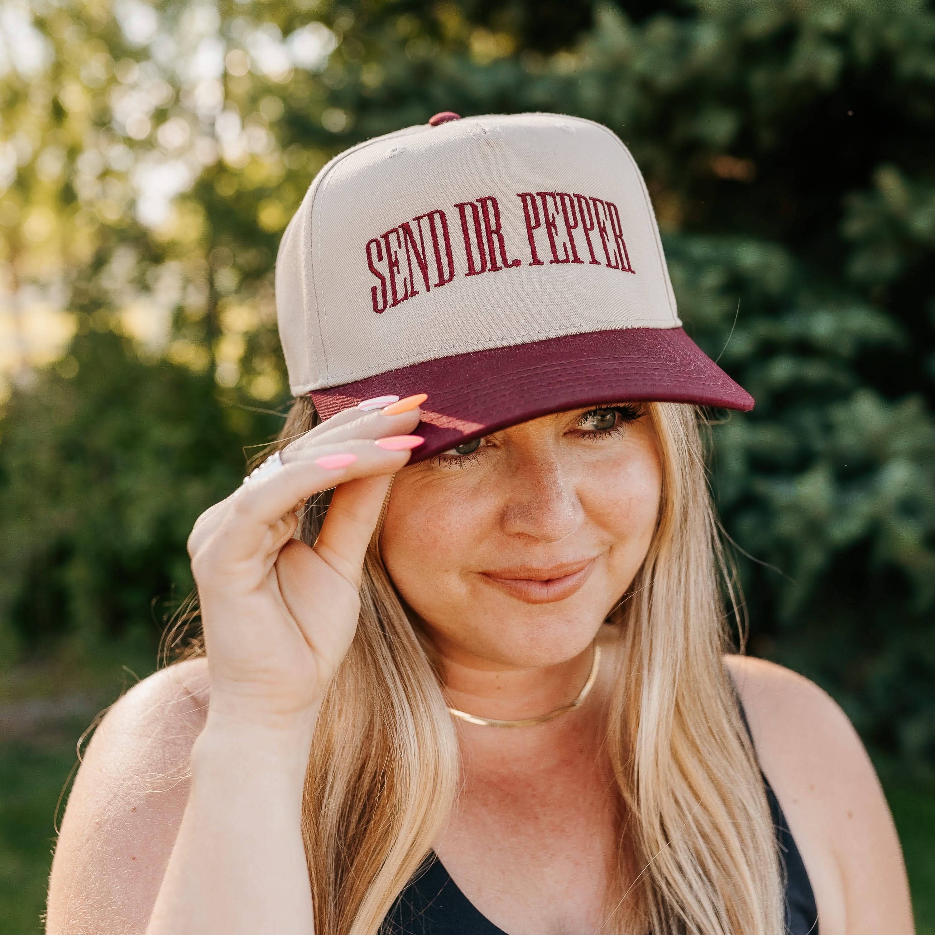 Maroon and cream trucker hat with bold red 'SEND DR. PEPPER' text, seen on model - Little Mama Shirt Shop