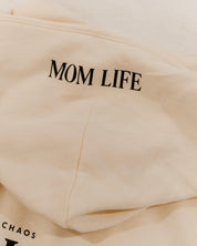 Hoodie in bone with black close up on hood with 'Mom Life' graphic on flat lay - Little Mama Shirt Shop