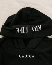 Hoodie front view in black with white 'Kid Life' on hood and stars on chest on flat lay - Little Mama Shirt Shop