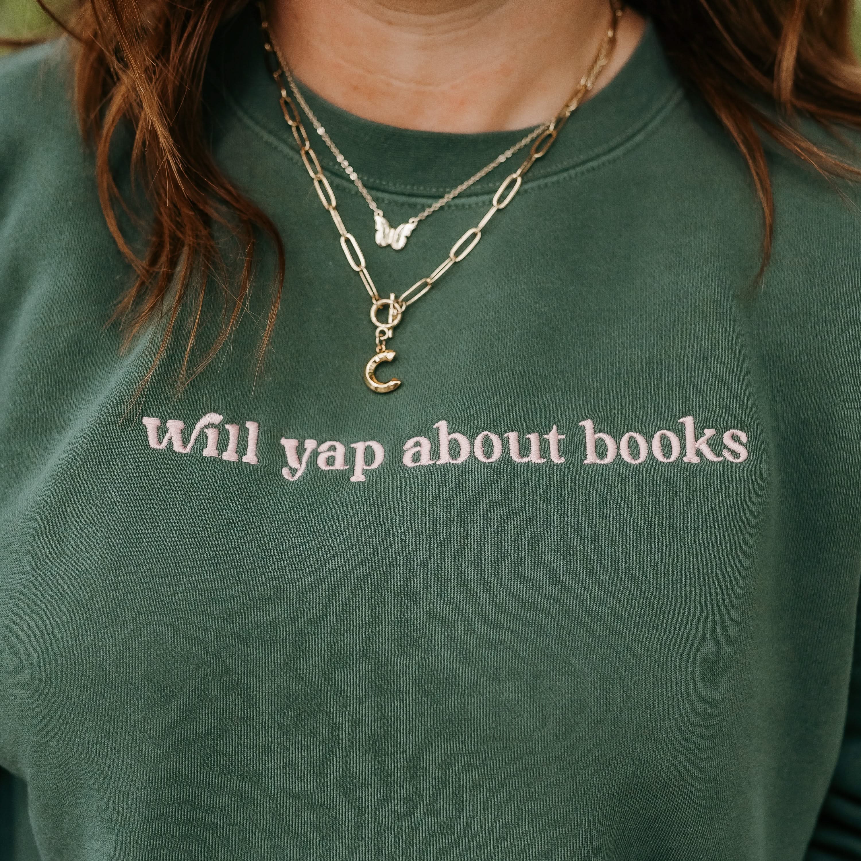 Embroidered “Will Yap About Books” pigment-dyed crewneck in pigment alpine with pink thread on model  – Little Mama Shirt Shop