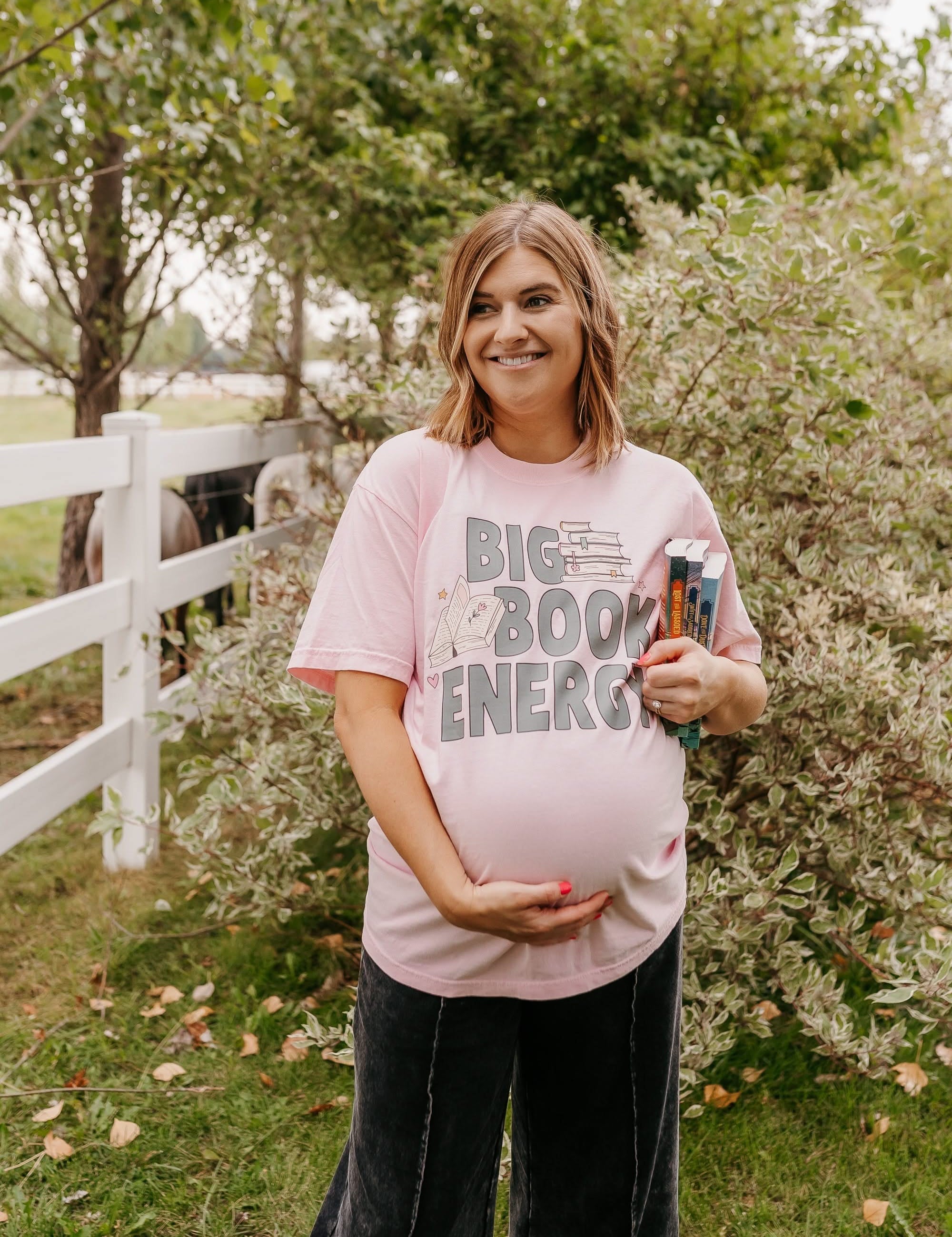 Comfort colors tee in blossom with 'Big Book Energy' graphic, shown on model – Little Mama Shirt Shop