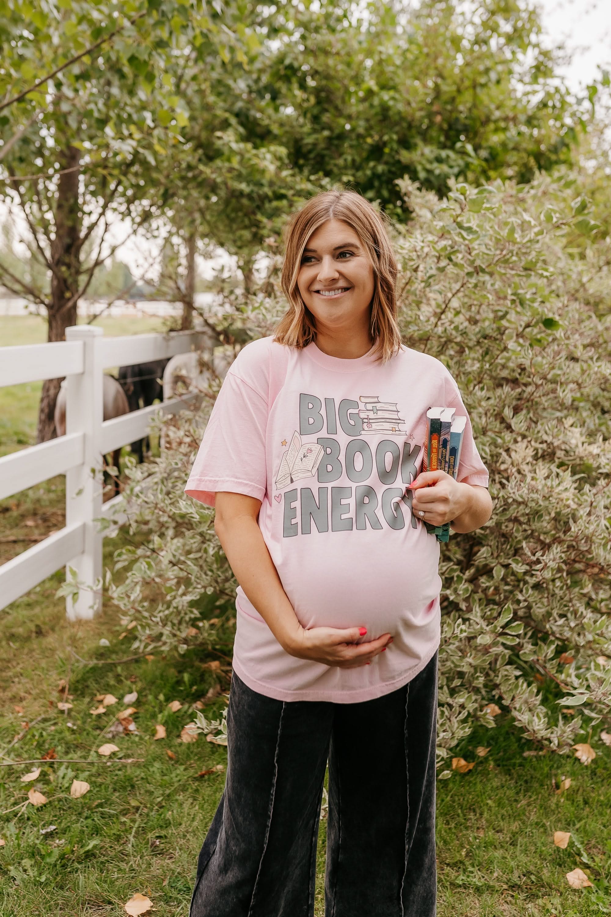 Comfort colors tee in blossom with 'Big Book Energy' graphic, shown on model – Little Mama Shirt Shop