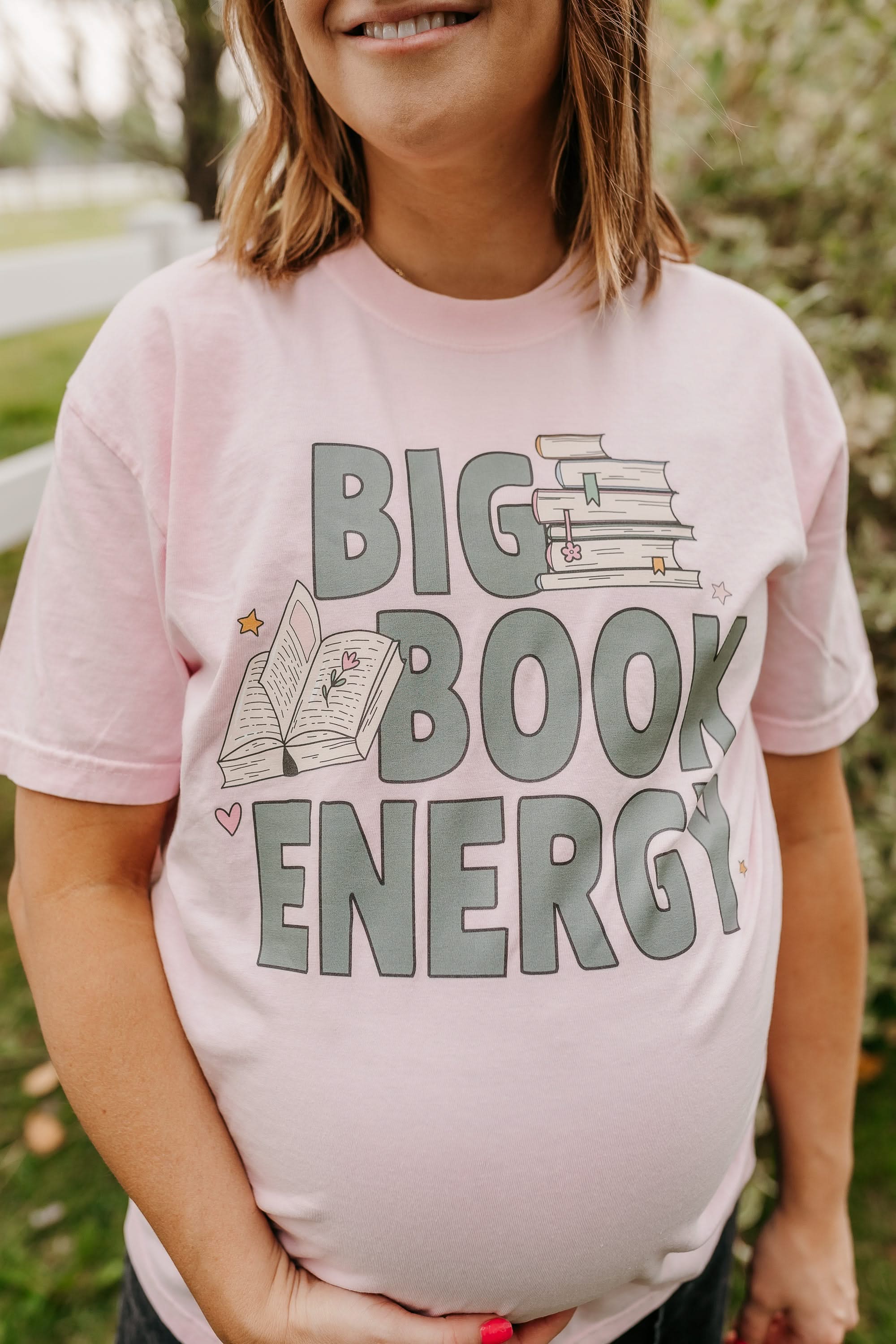 Comfort colors tee in blossom with 'Big Book Energy' graphic, shown on model – Little Mama Shirt Shop