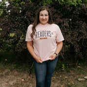 Unisex Comfort Colors tee with “Late Night Readers Club BYOB” design in blossom, on model – Little Mama Shirt Shop