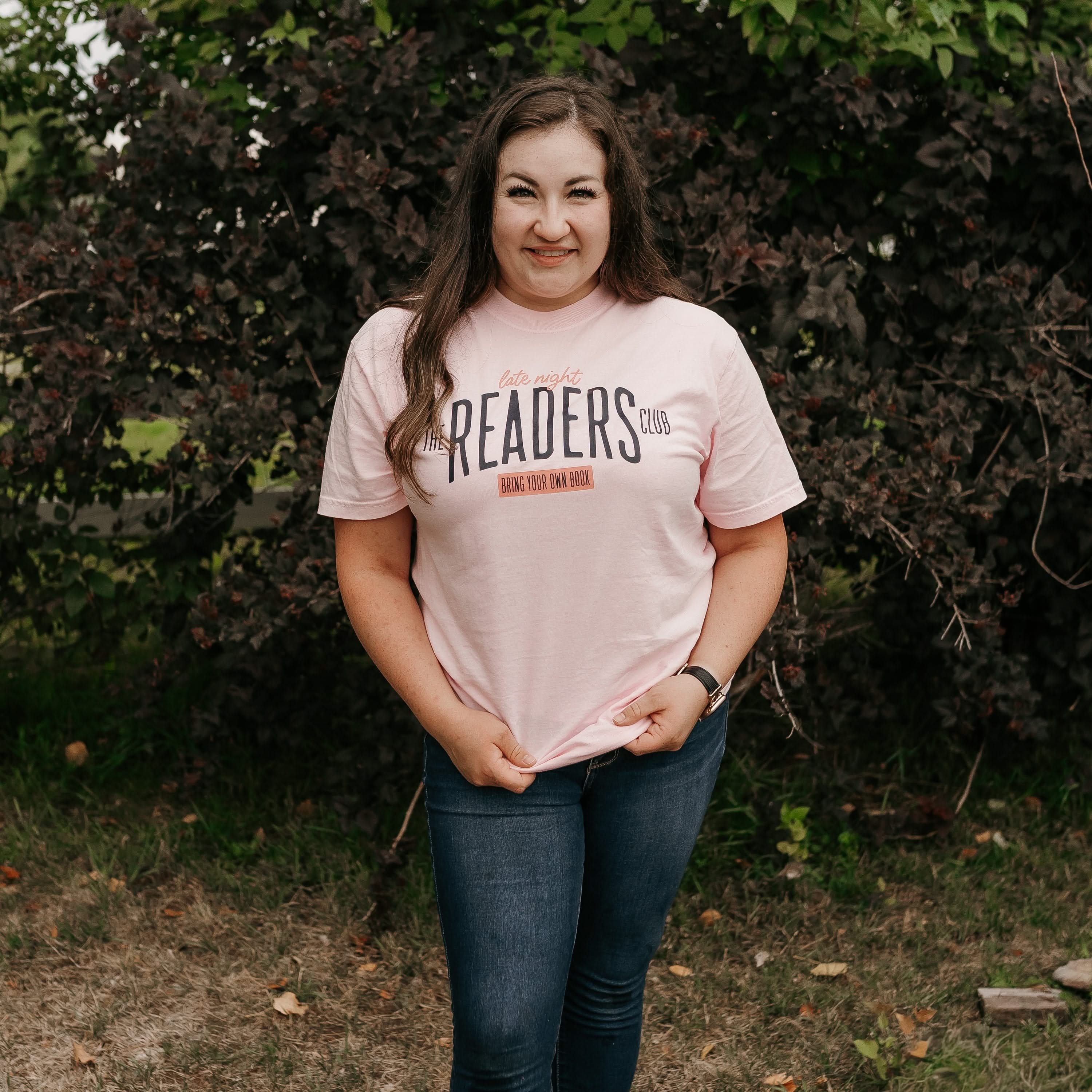 Unisex Comfort Colors tee with “Late Night Readers Club BYOB” design in blossom, on model – Little Mama Shirt Shop