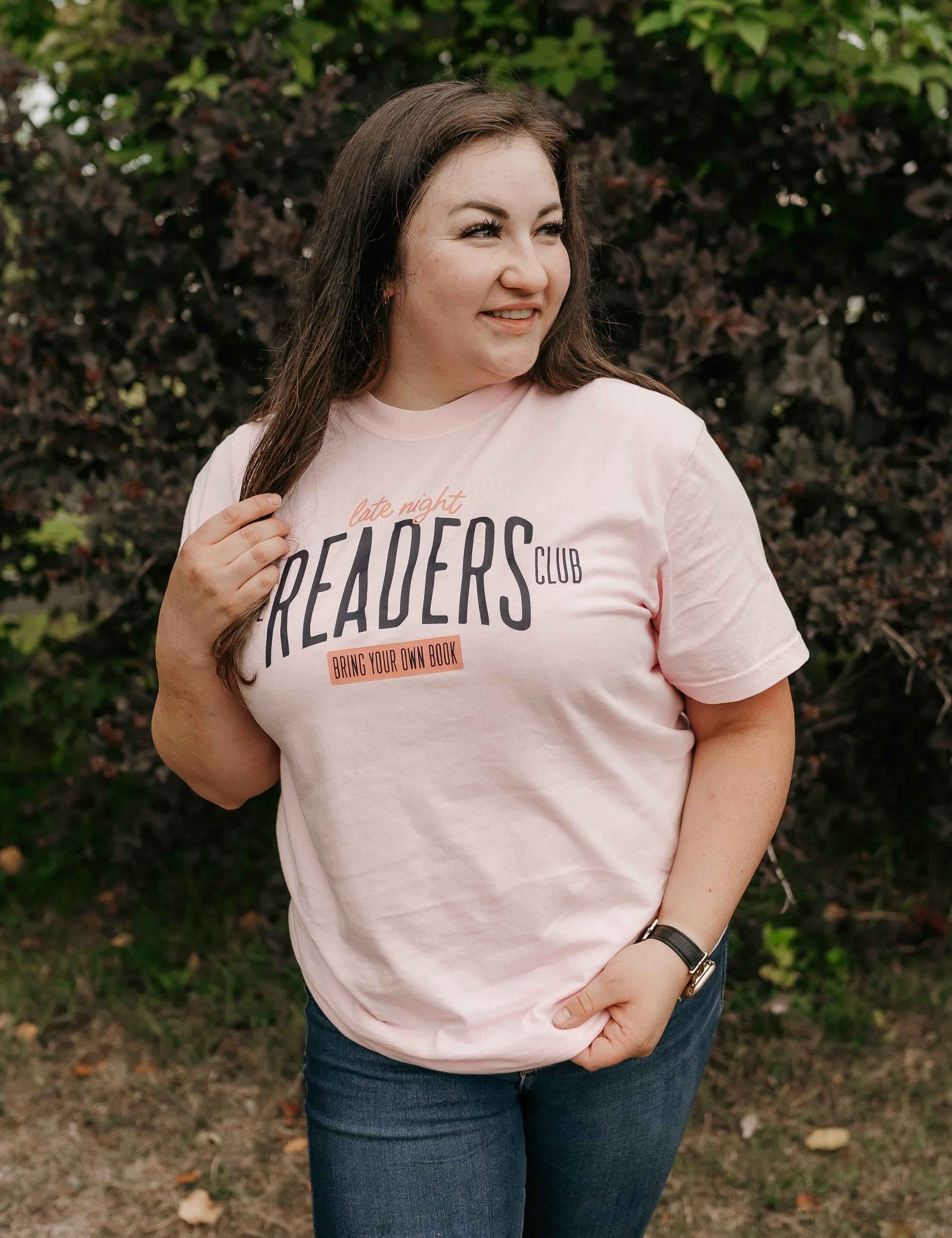 Unisex Comfort Colors tee with “Late Night Readers Club BYOB” design in blossom, on model – Little Mama Shirt Shop