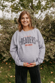 Unisex fleece sweatshirt in gray with “Late Night Readers Club BYOB” design on model – Little Mama Shirt Shop
