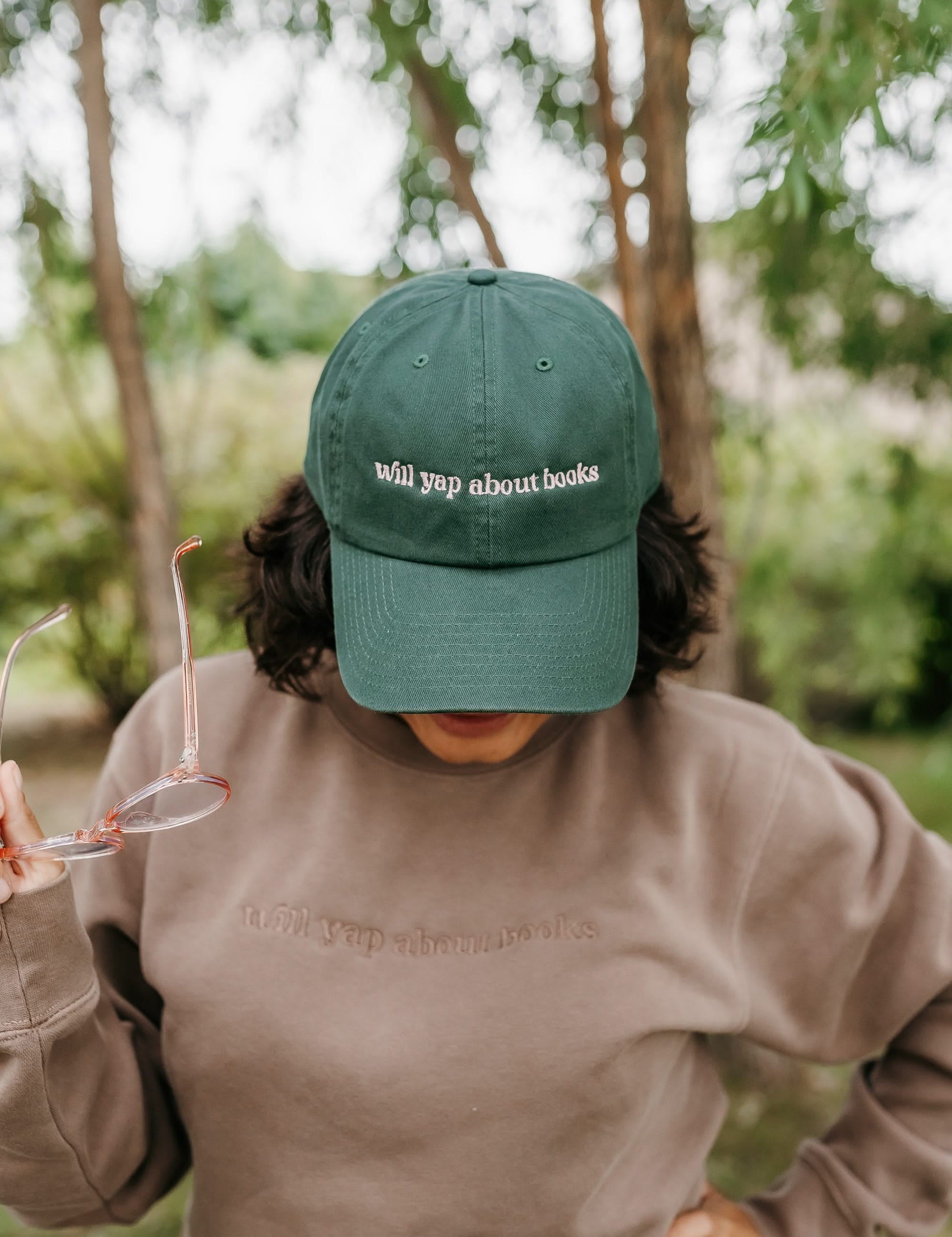 ’47 brand hat embroidered with “Will Yap About Books” design in dark green with pink thread on model – Little Mama Shirt Shop