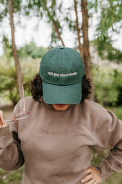 ’47 brand hat embroidered with “Will Yap About Books” design in dark green with pink thread on model – Little Mama Shirt Shop