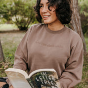 Embroidered “Will Yap About Books” pigment-dyed crewneck in pigment clay - tone on tone on model  – Little Mama Shirt Shop