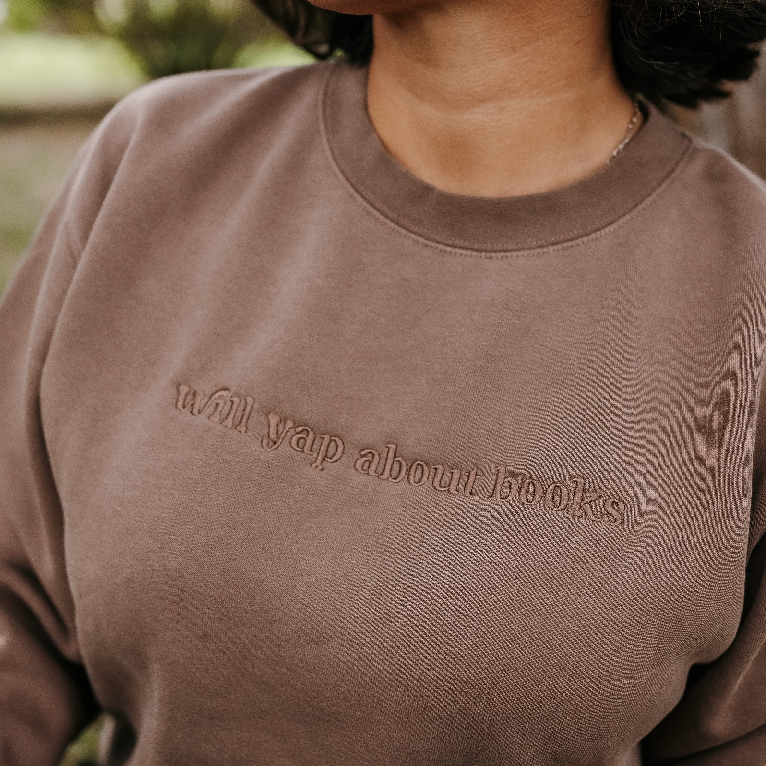 Embroidered “Will Yap About Books” pigment-dyed crewneck in pigment clay - tone on tone on model  – Little Mama Shirt Shop