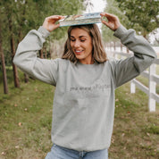 Unisex “One More Chapter” crewneck in sage with cozy tone on tone book lover illustration, on model – Little Mama Shirt Shop
