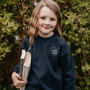 Child sweater in navy w/ light blue detail with a 'book lover' heart graphic on the front and 'What are you reading?' graphic on back, shown on model – Little Mama Shirt Shop