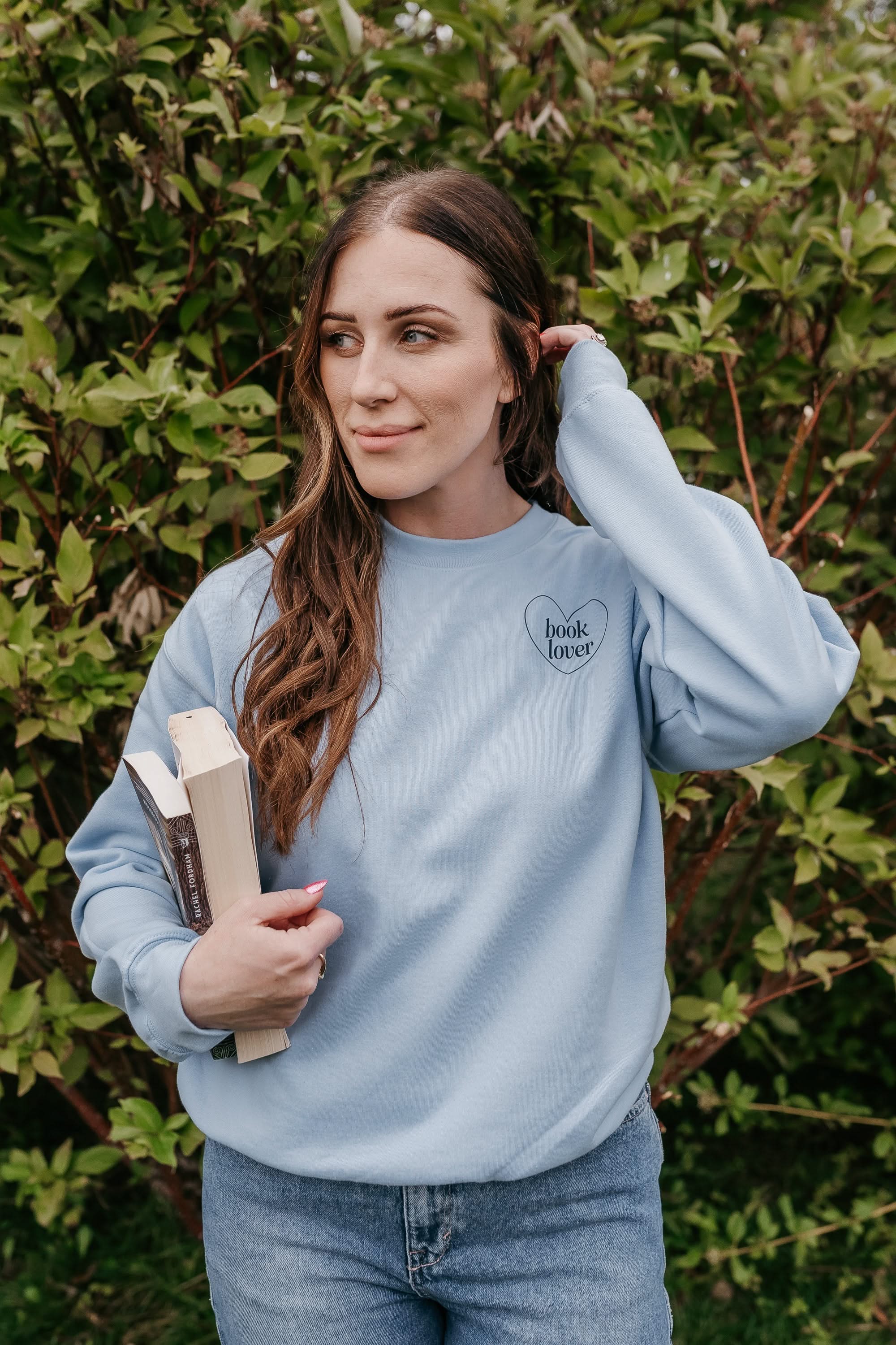 Basic Fleece in light blue w/ navy detail with a 'book lover' heart graphic on the front and 'What are you reading?' graphic on back, shown on model – Little Mama Shirt Shop