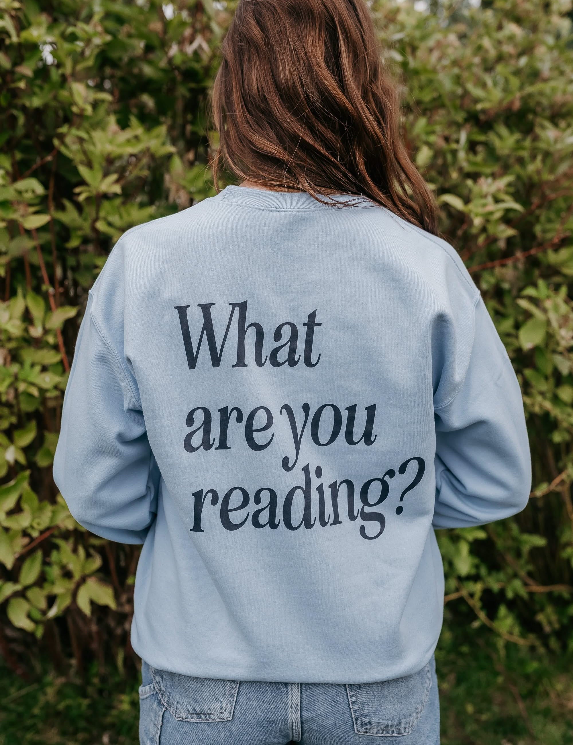  navy detail with a 'book lover' heart graphic on the front and 'What are you reading?' graphic on back, shown on model – Little Mama Shirt Shop
