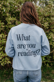 Basic Fleece in light blue w/ navy detail with a 'book lover' heart graphic on the front and 'What are you reading?' graphic on back, shown on model – Little Mama Shirt Shop