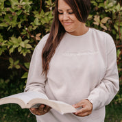 Embroidered “Will Yap About Books” pigment-dyed crewneck in pigment ivory - tone on tone on model  – Little Mama Shirt Shop