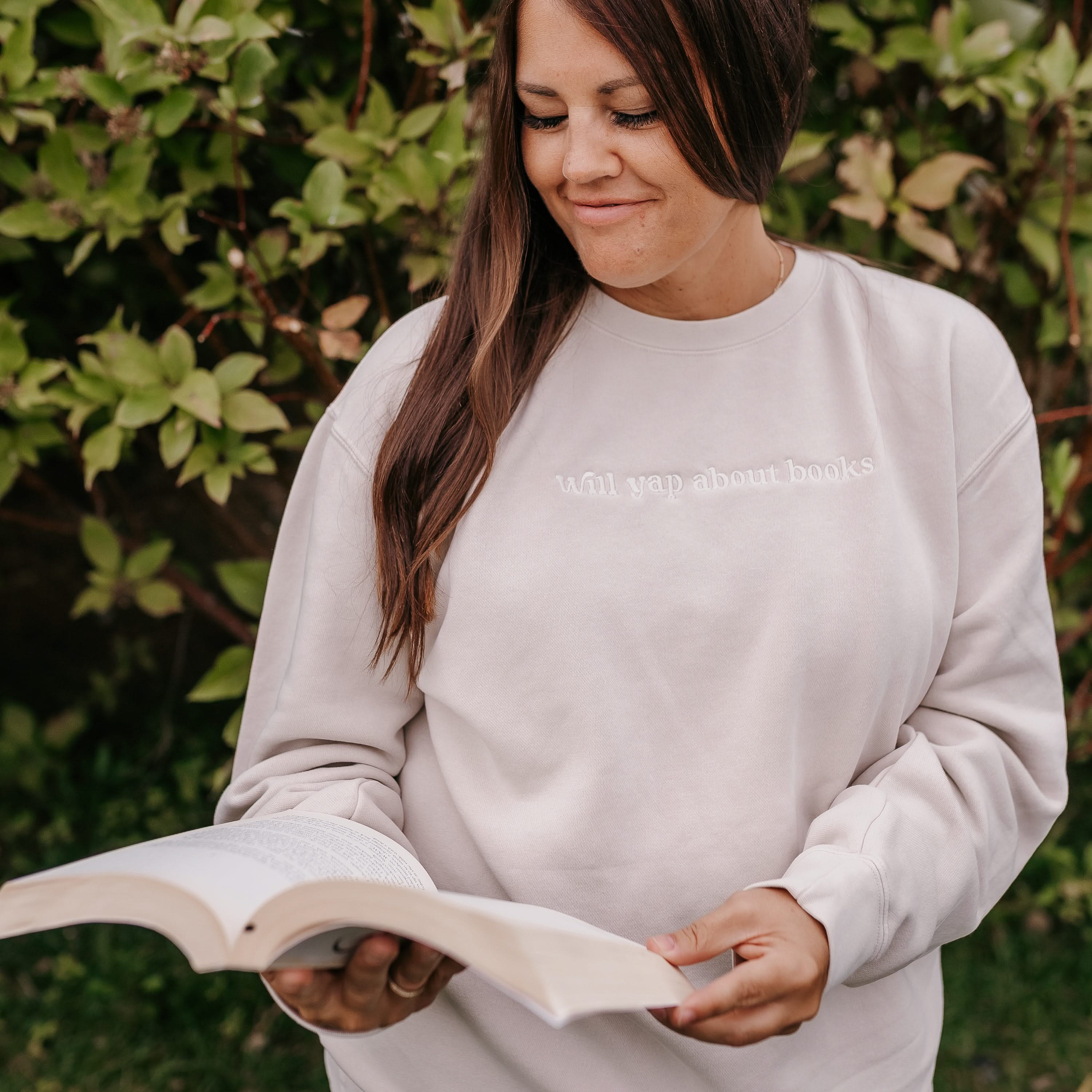 Embroidered “Will Yap About Books” pigment-dyed crewneck in pigment ivory - tone on tone on model  – Little Mama Shirt Shop