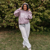 Unisex hoodie in paragon with 'BOOKED' arched text on model – Little Mama Shirt Shop
