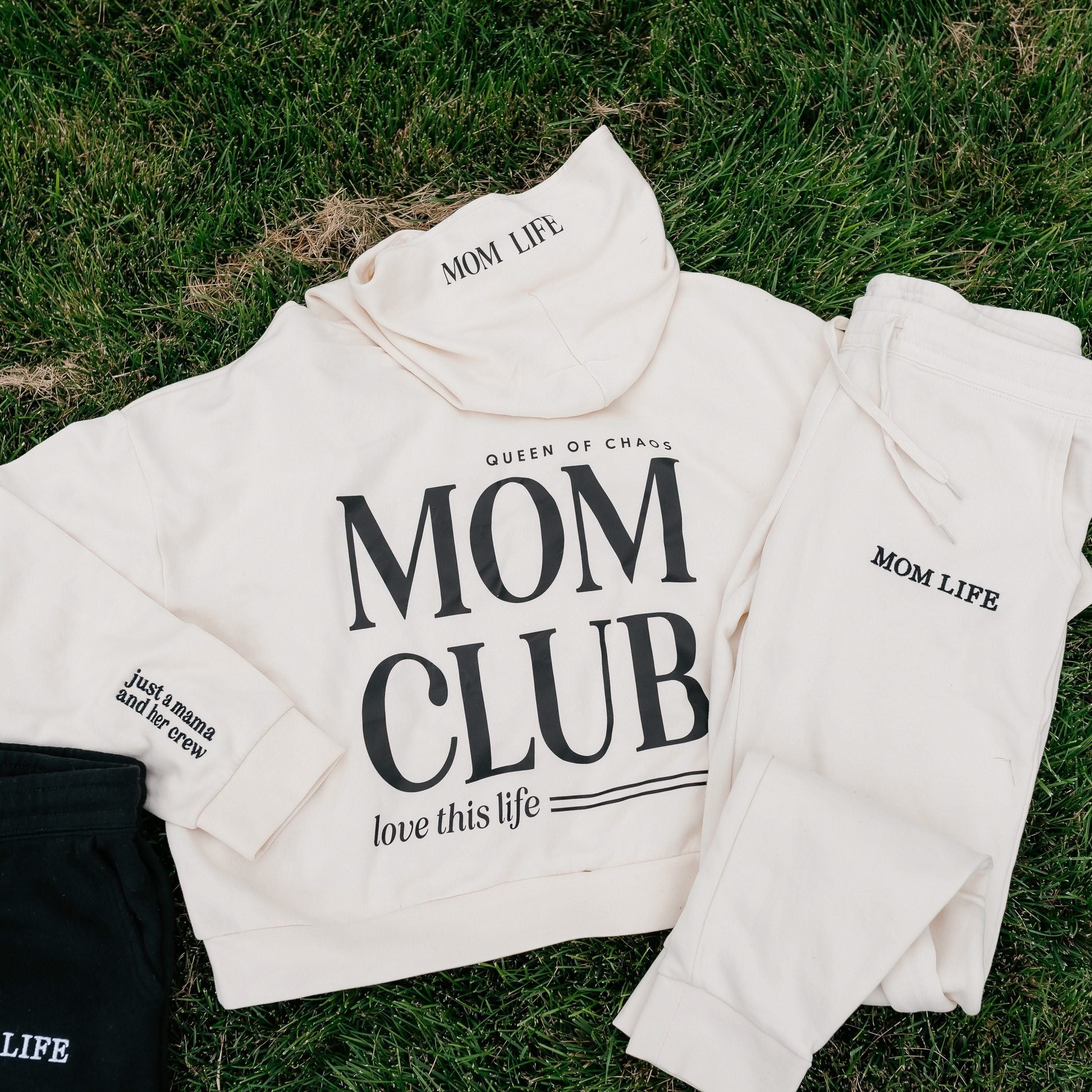 Hoodie and jogger set in bone with black 'Mom Club' graphic on flat lay - Little Mama Shirt Shop