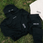 Hoodie and jogger set in black with white  'Mom Life' graphic on flat lay - Little Mama Shirt Shop