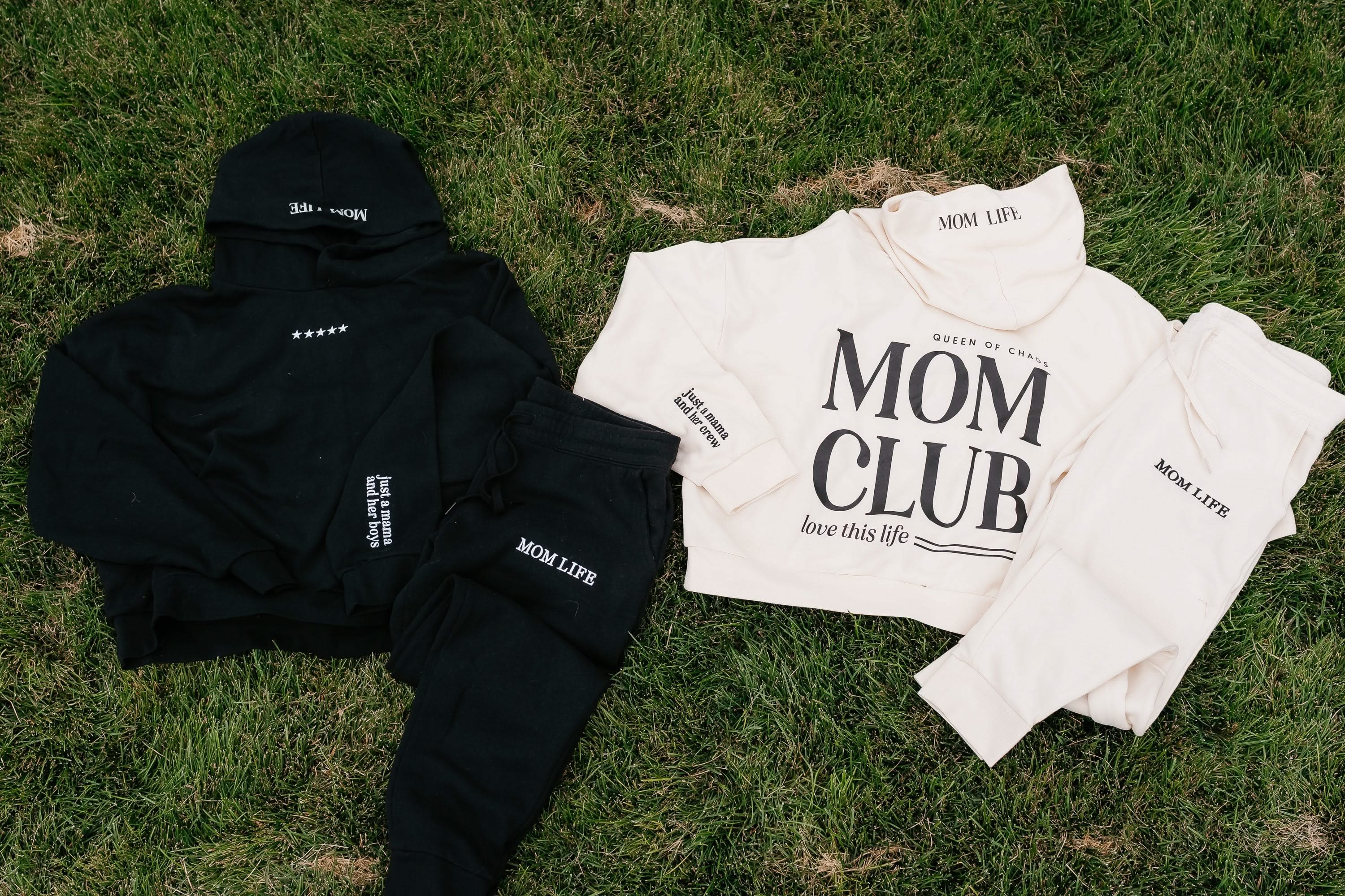 Hoodie and jogger set in both bone with black and black with white 'Mom Club' graphic on flat lay - Little Mama Shirt Shop