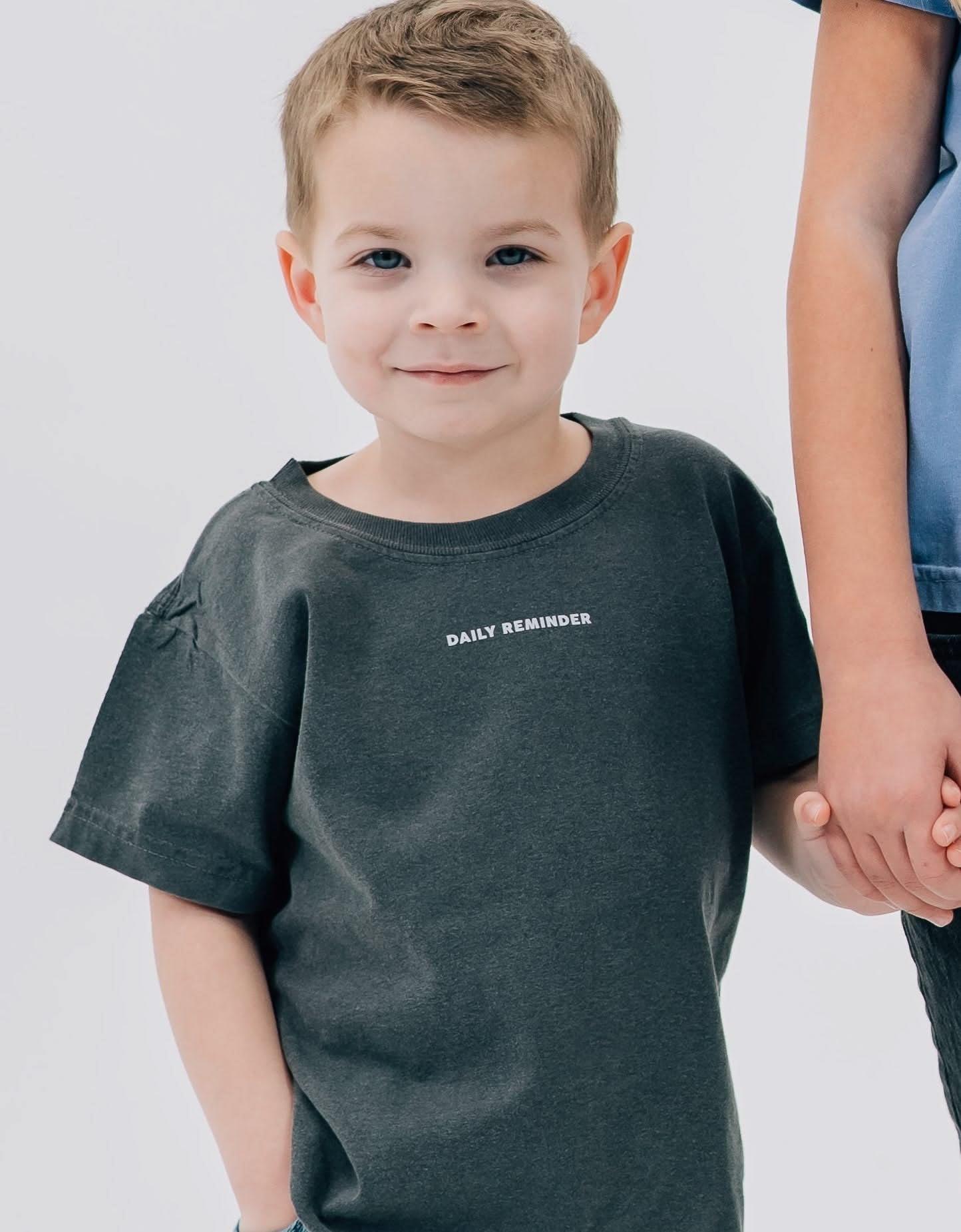 Pepper child comfort colors tee with 'daily reminder' printed on front, seen on model - Little Mama Shirt Shop