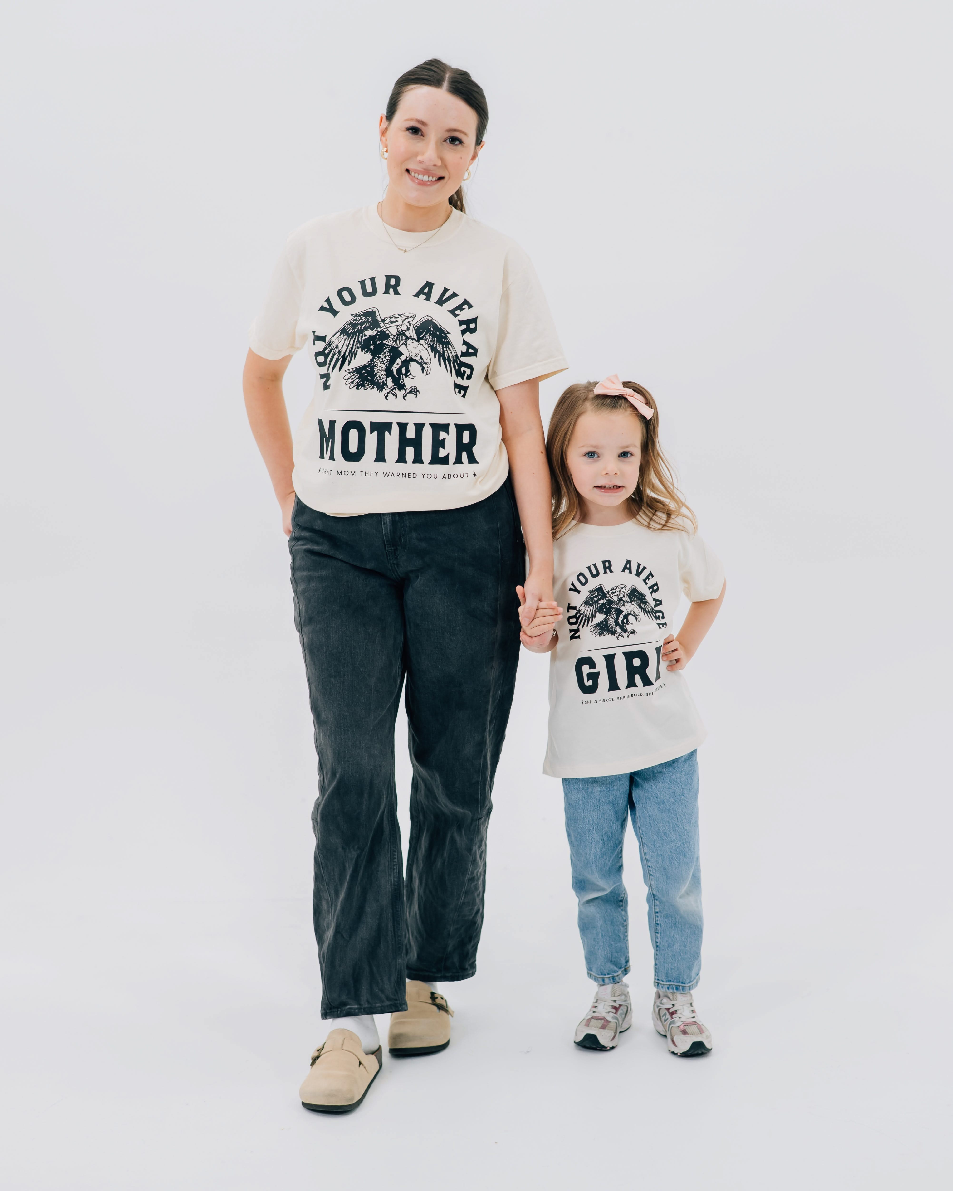 Adult and child tee in ivory and natural with "Not Your Average" design on front, shown on models – Little Mama Shirt Shop