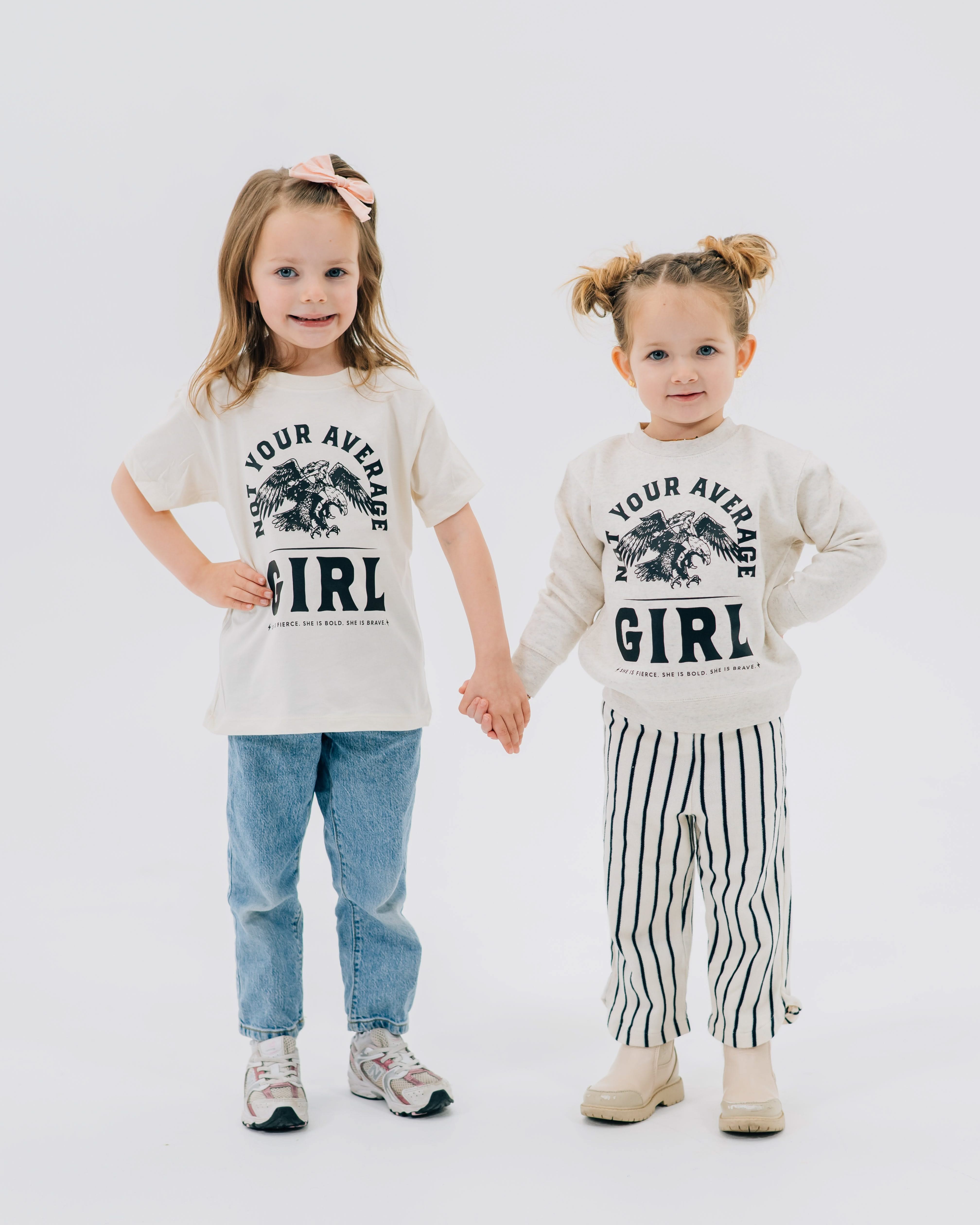Child tee and Child sweater in natural with "Not Your Average" design on front, shown on models  – Little Mama Shirt Shop